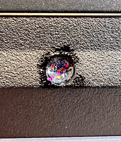 Anti-tamper glitter on screw, laptop #1.